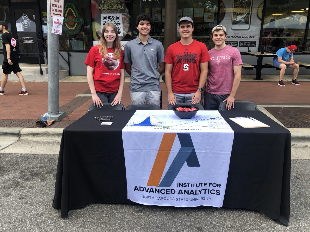 Group of four students at table