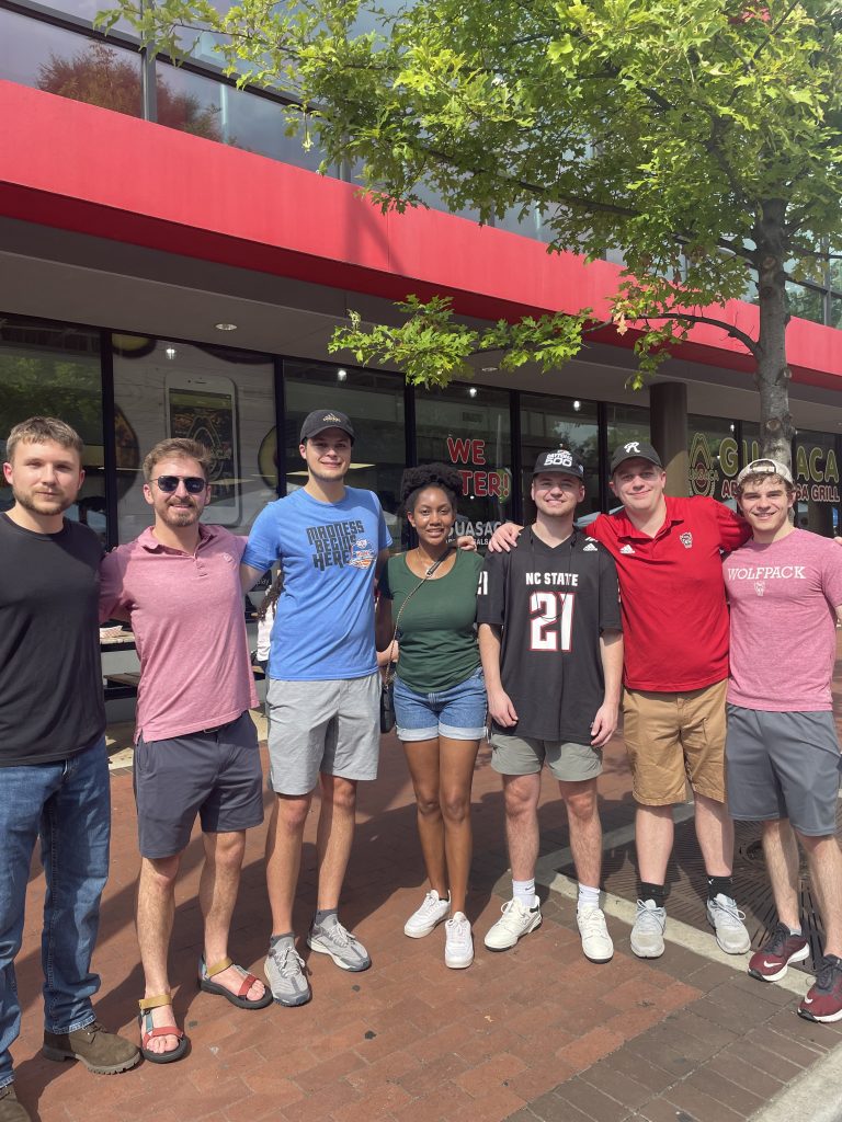 Group of seven students standing together on Hillsborough Street