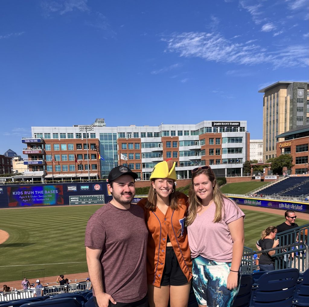 A man and two women at Durham Bulls ball park.
