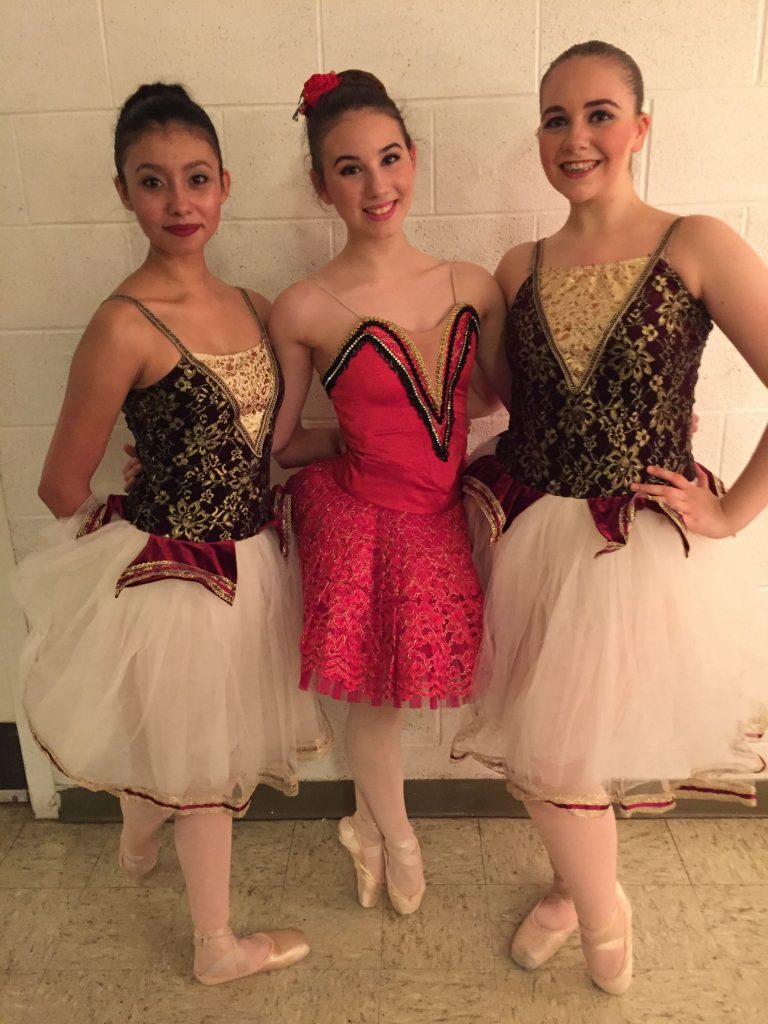 Three ballet dancers in costume posing backstage
