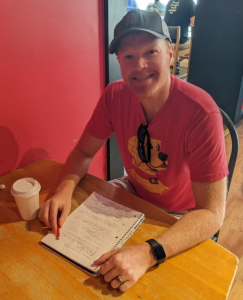 Man at table with notebook